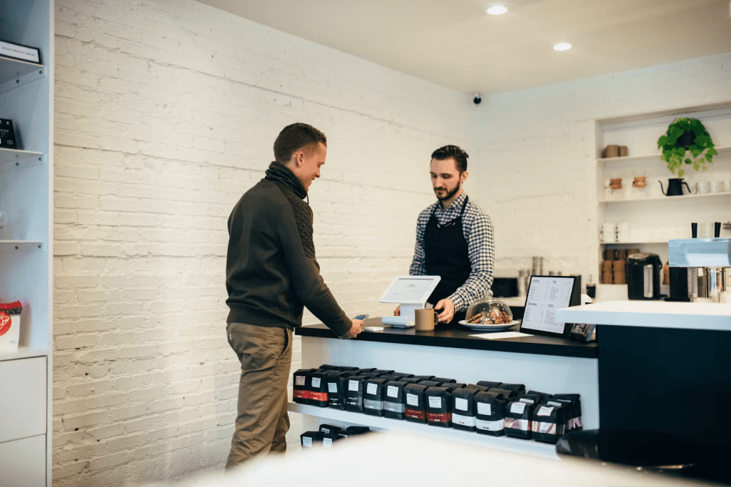 A customer chatting with a shopkeeper across the counter