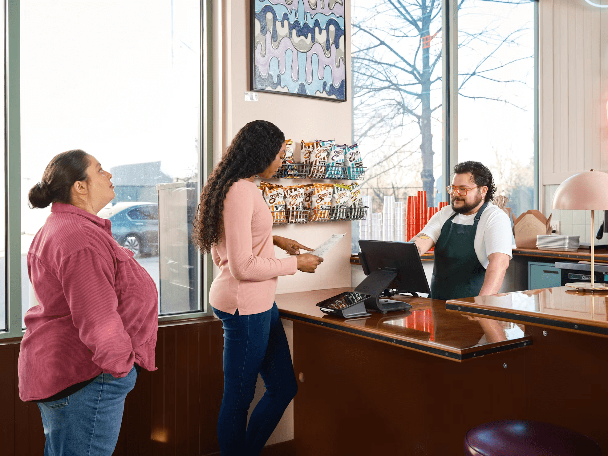 A customer ordering at a café counter